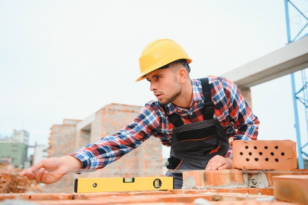 Using,Bricks ,Young,Construction,Worker,In,Uniform,Is,Busy,At