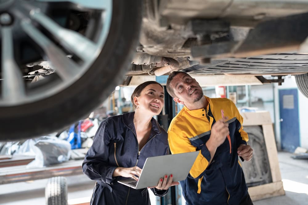 Caucasian,Man,And,Beautiful,Woman,Mechanic,Use,Notebook,Computer,Checking