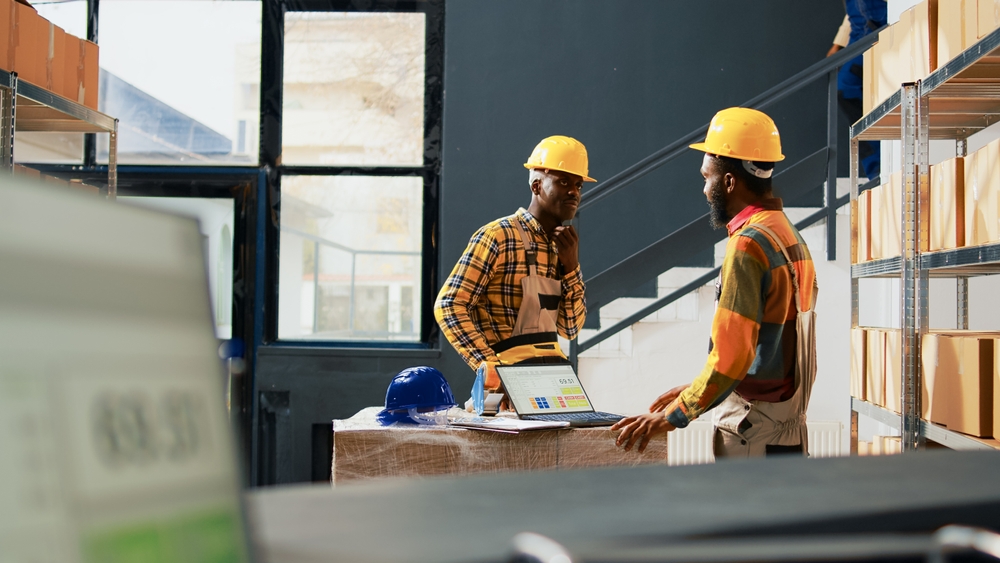 Young,Men,And,Woman,Working,On,Packing,Supplies,,Having,Fun