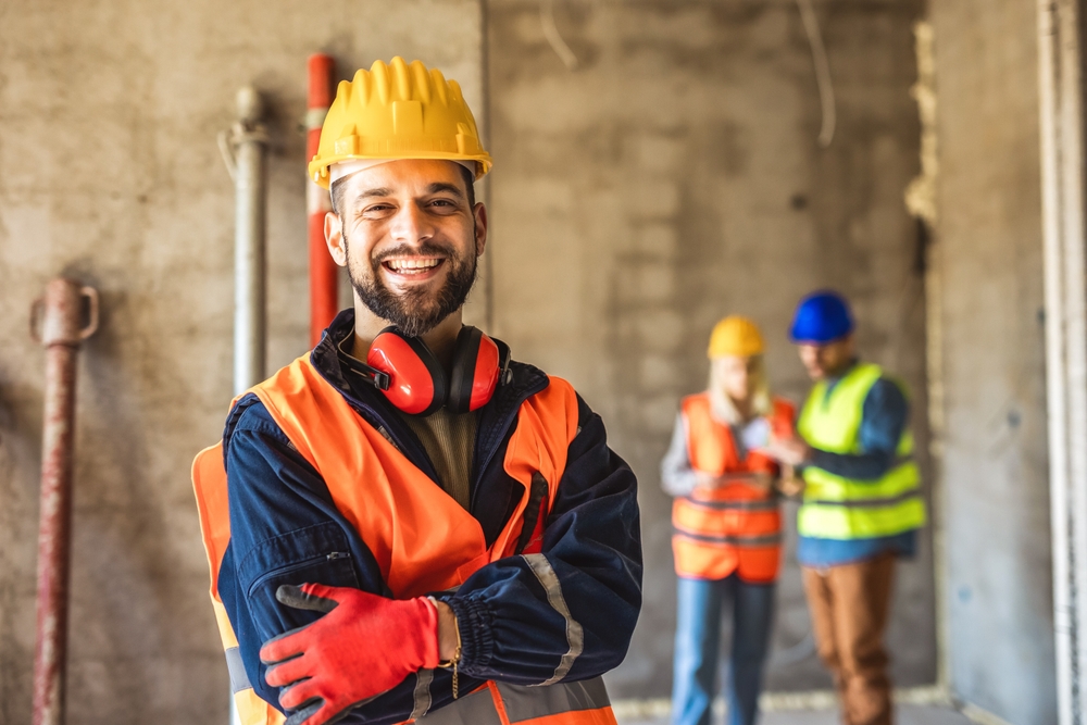 Construction,Site,Manager,Standing,Wearing,Safety,Vest,And,Helmet,,Thinking